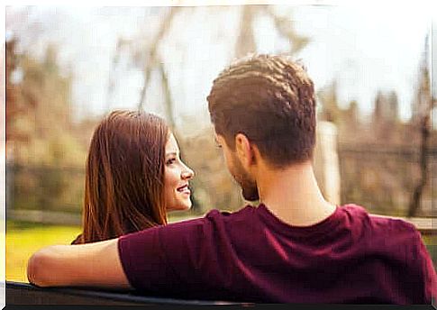 A couple chatting on a bench