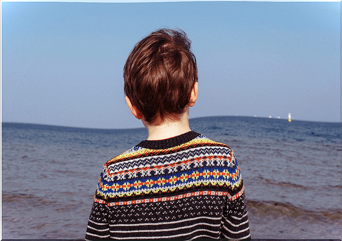 child facing the sea