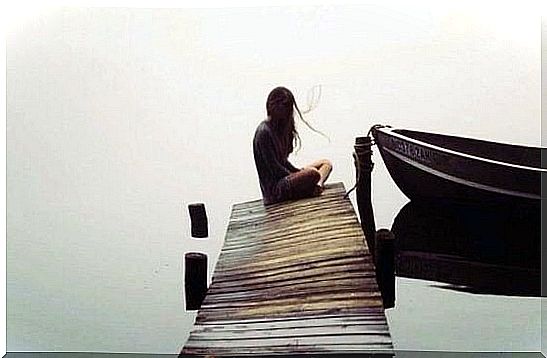 woman sitting at the end of a pontoon