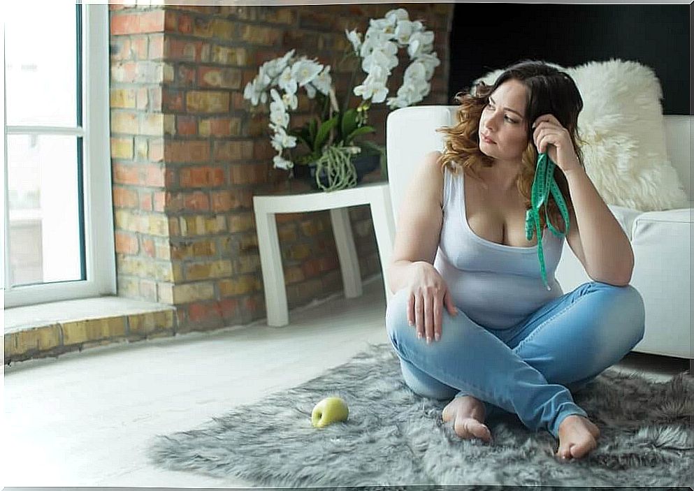 A frustrated woman sitting on the floor.