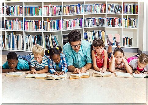 teacher reading with his students