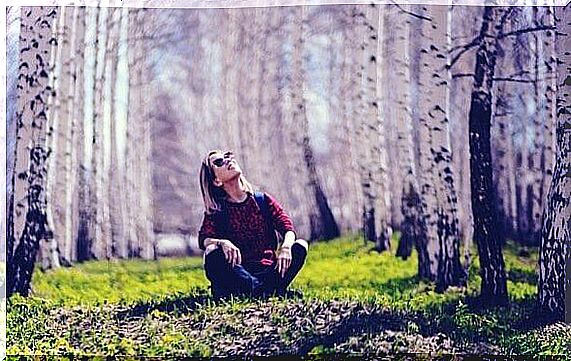 woman sitting in the forest